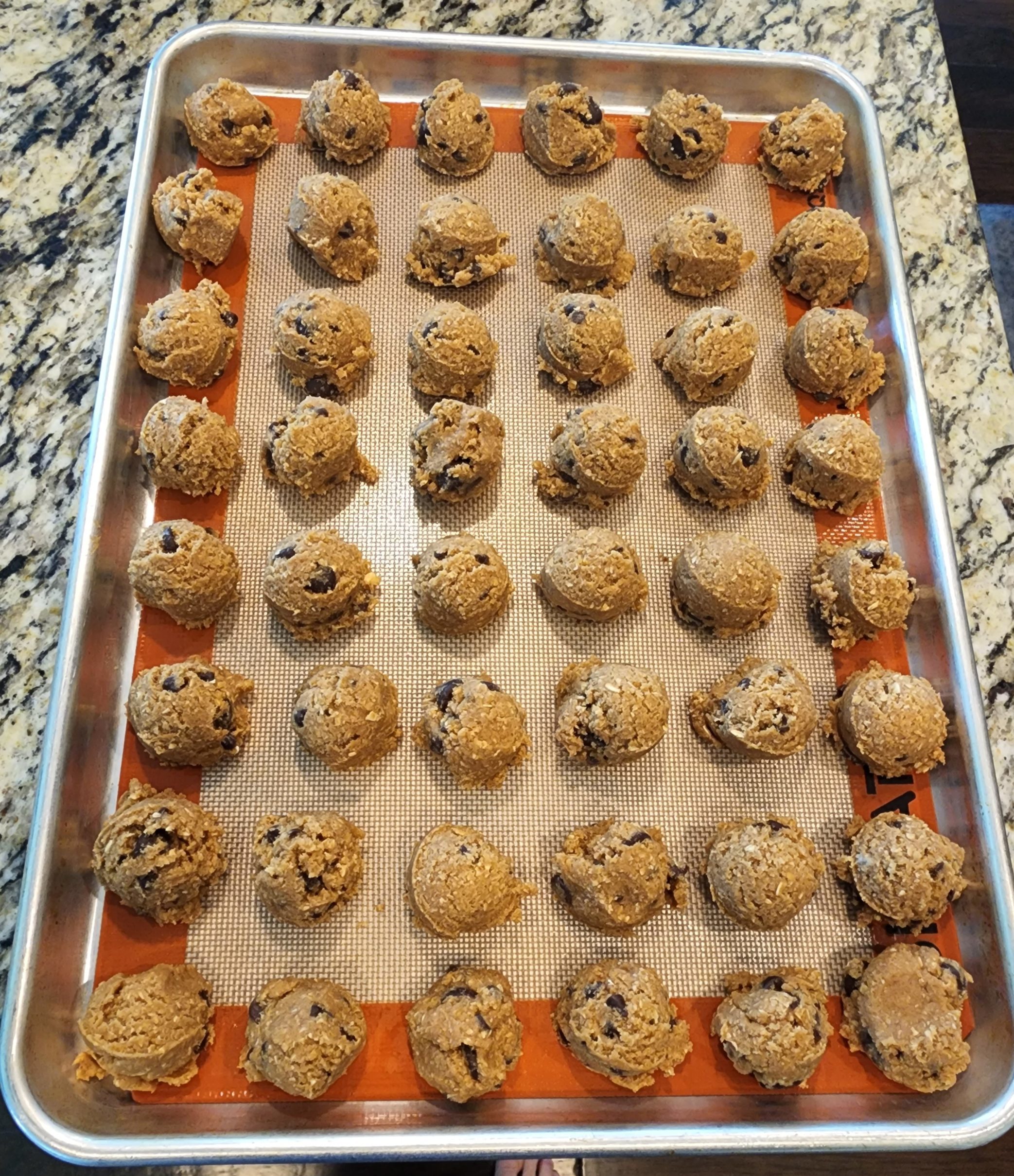 Chocolate Chip Cookie dough balls frozen on sheet pan